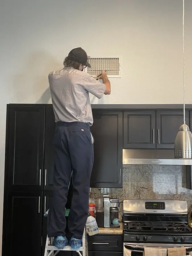 Technician inspecting an air vent during HVAC service in Jan Phyl Village